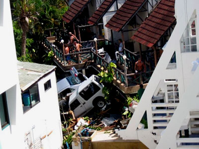 Cars pushed against a building in Thailand
