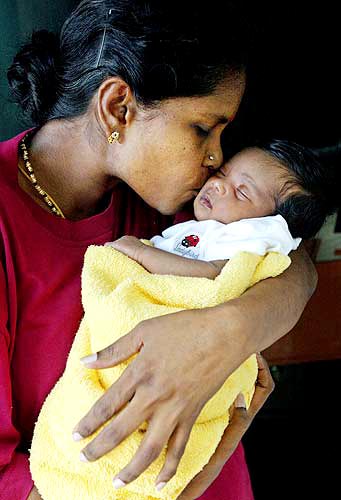 Tsunami Pictures: #8 - Happy to be alive: A mother kisses her baby