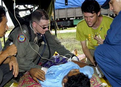 U.S. Navy personnel assist a wounded man