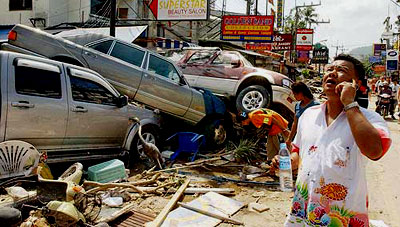 Tsunami Pictures: #7 - Three cars piled one atop the other on a street in Thailand