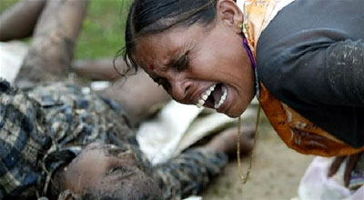 A woman screams in grief as she mourns the loss of her child